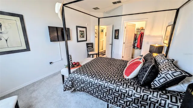 a bedroom with a bed and a mirror