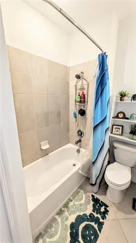 a bathroom with a toilet and a bathtub