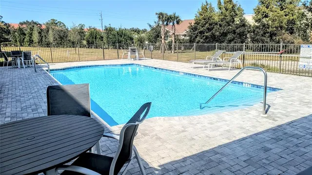 a view of a swimming pool with a patio