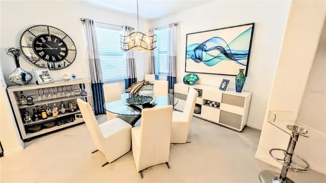 a living room with furniture a rug and a wall painting