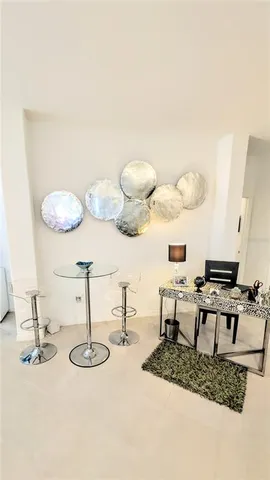 a living room with dining table and chairs