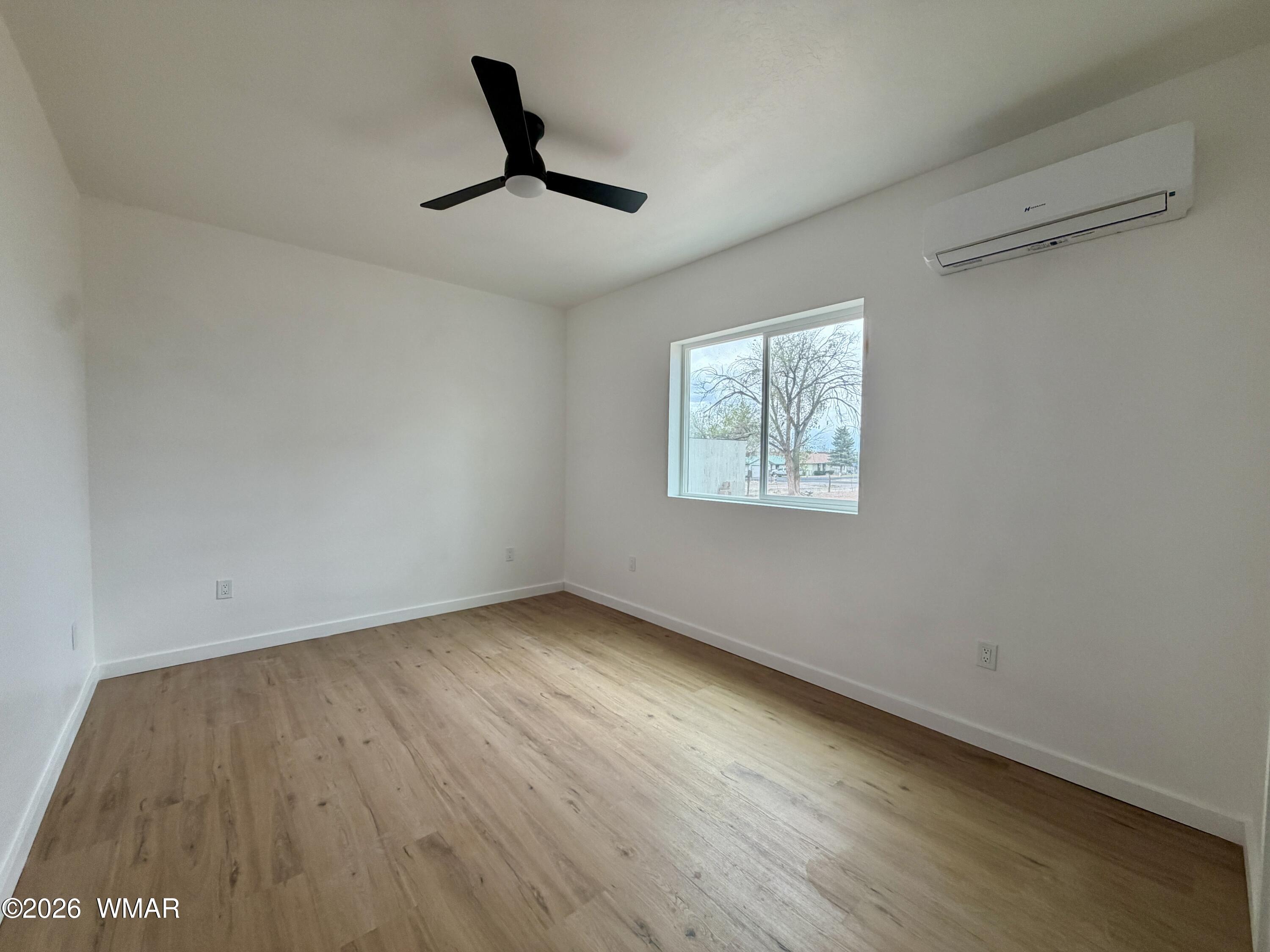 731 Tori Circle Springerville, AZ 85938 - Photo 9 of 19 a view of empty room with wooden floor and fan