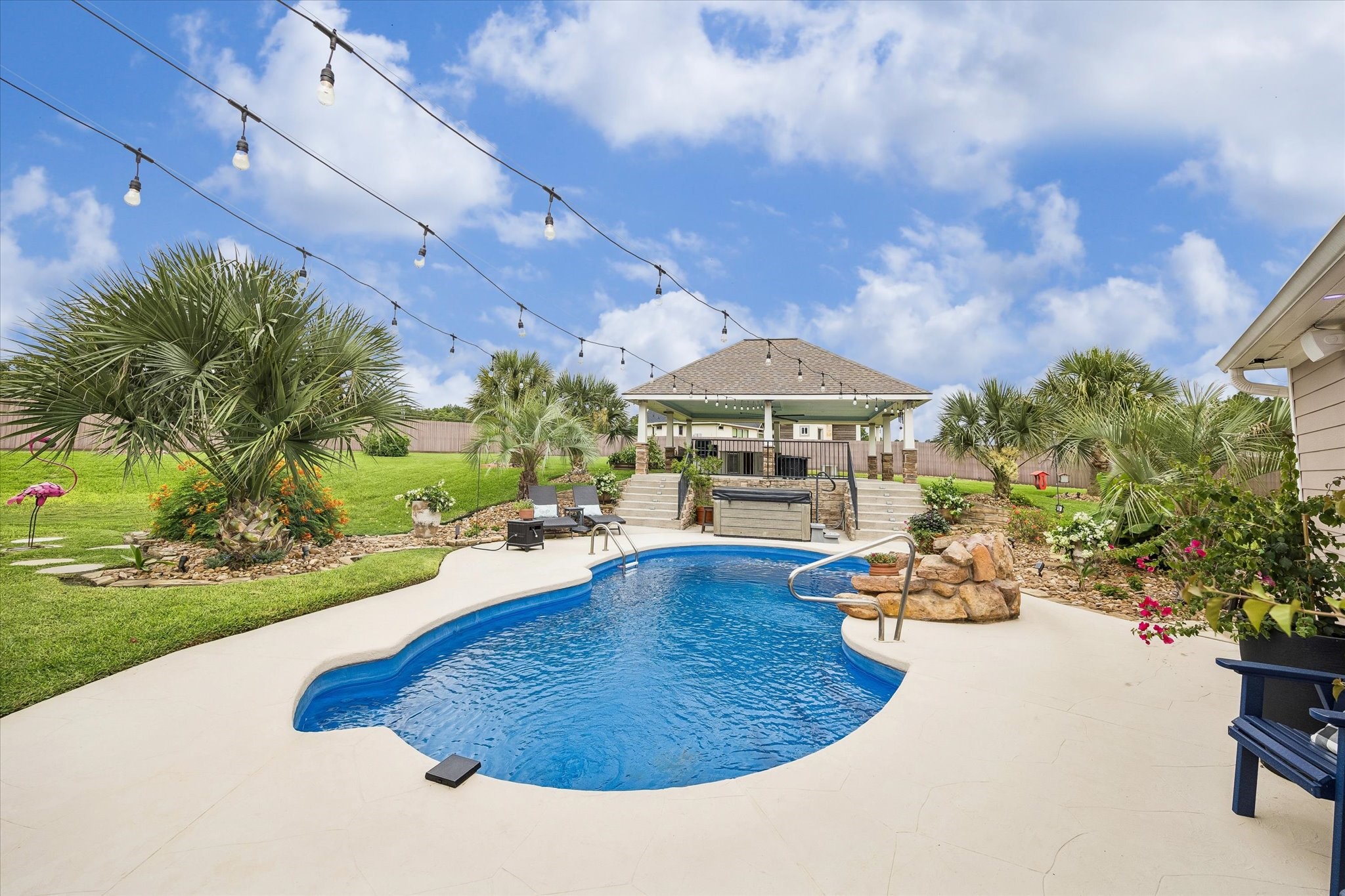 19973 Peel Road Montgomery, TX 77356 - Photo 25 of 31 Stunning pool with waterfall, equipped with a pool chiller for the hot summer months, and a pool heater for off-season!