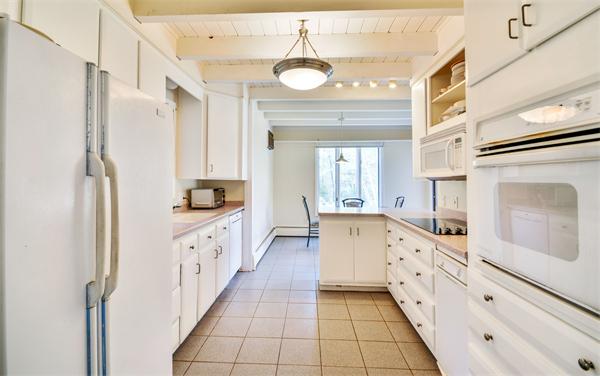 8 Plummer Road Boxford, MA 01921 - Photo 12 of 27 a large white kitchen with granite countertop a sink and a refrigerator