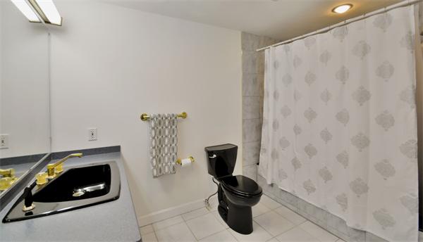 8 Plummer Road Boxford, MA 01921 - Photo 18 of 27 a bathroom with a toilet and a shower curtain