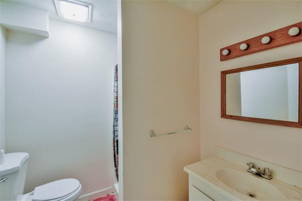 8 Plummer Road Boxford, MA 01921 - Photo 7 of 27 a bathroom with a toilet sink vanity and mirror