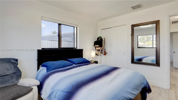 a bedroom with a bed and a window