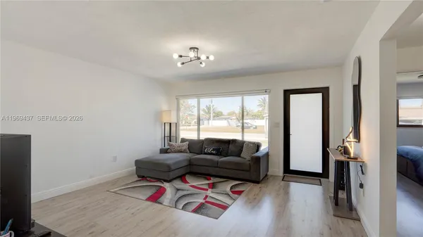 a living room with furniture and a flat screen tv