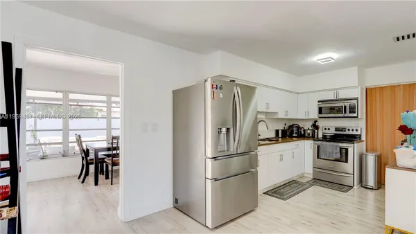 a kitchen with stainless steel appliances a refrigerator sink and stove
