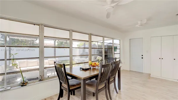 a view of a dining room with furniture and a large window