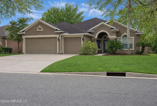 a front view of a house with a yard and garage