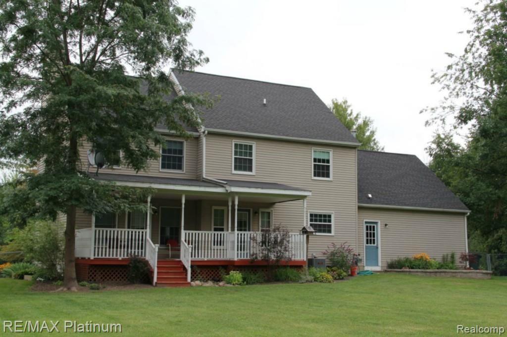 4179 Potts Road Fowlerville, MI 48836 - Photo 2 of 24 Rear view of home with covered porch
