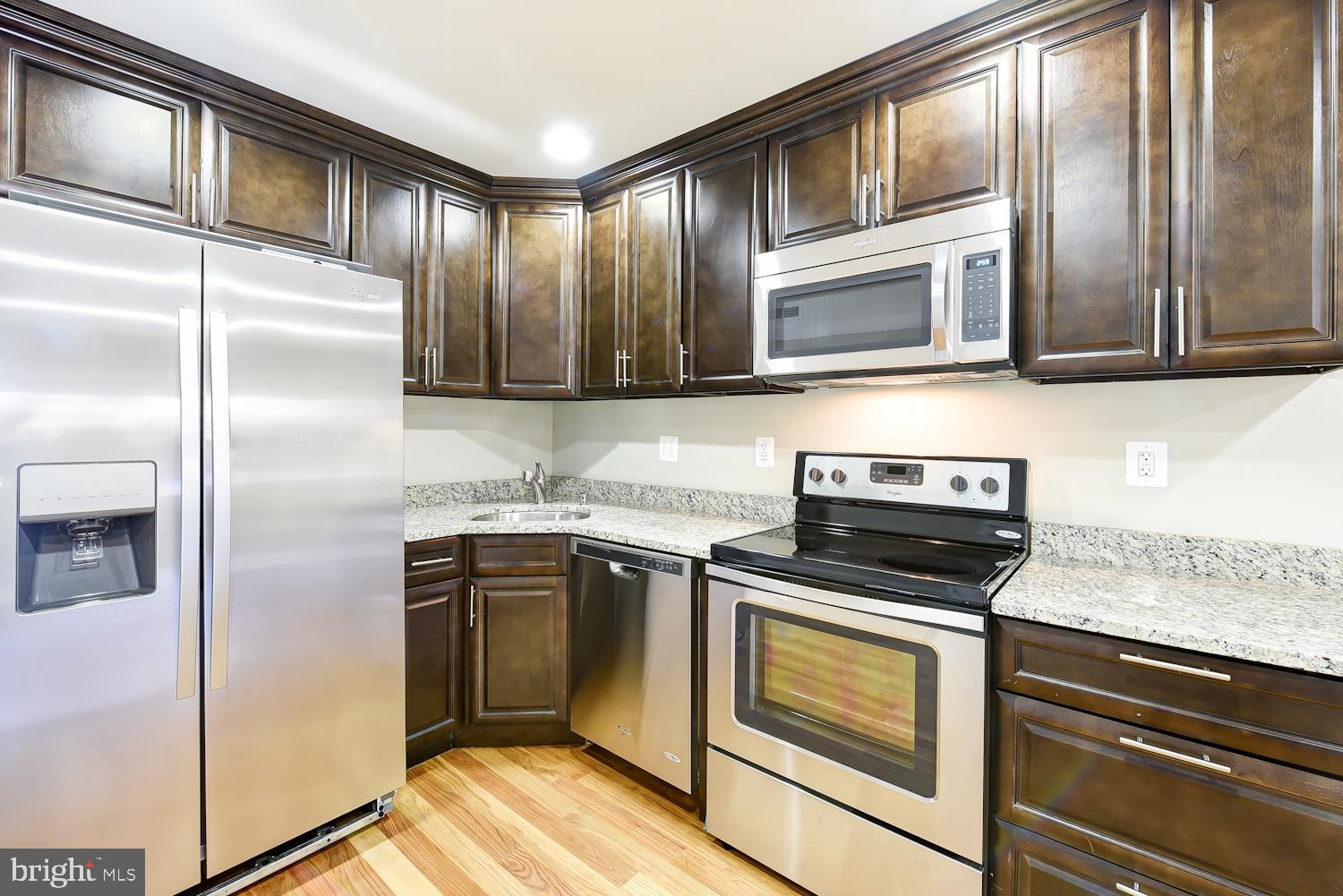 2031 Benning Road Northeast, Unit B Washington, DC 20002 - Photo 5 of 22 a kitchen with stainless steel appliances granite countertop a stove microwave and refrigerator