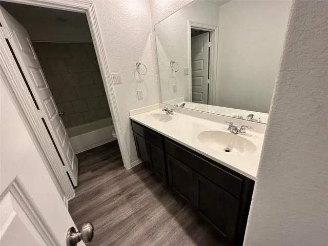 a bathroom with a double vanity sink and a mirror