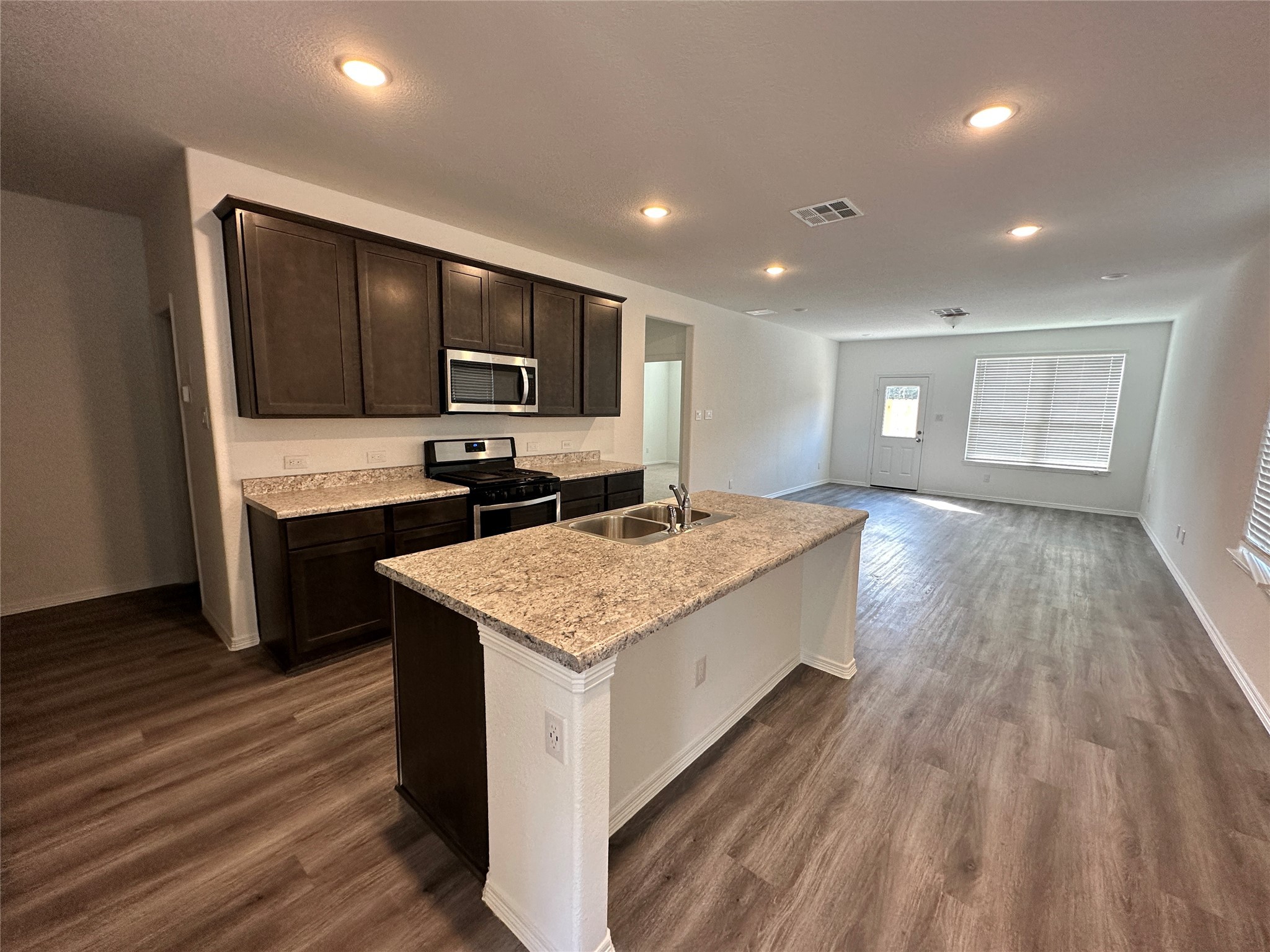 16572 Moss Lane Porter, TX 77365 - Photo 2 of 17 a kitchen with kitchen island sink stove and refrigerator