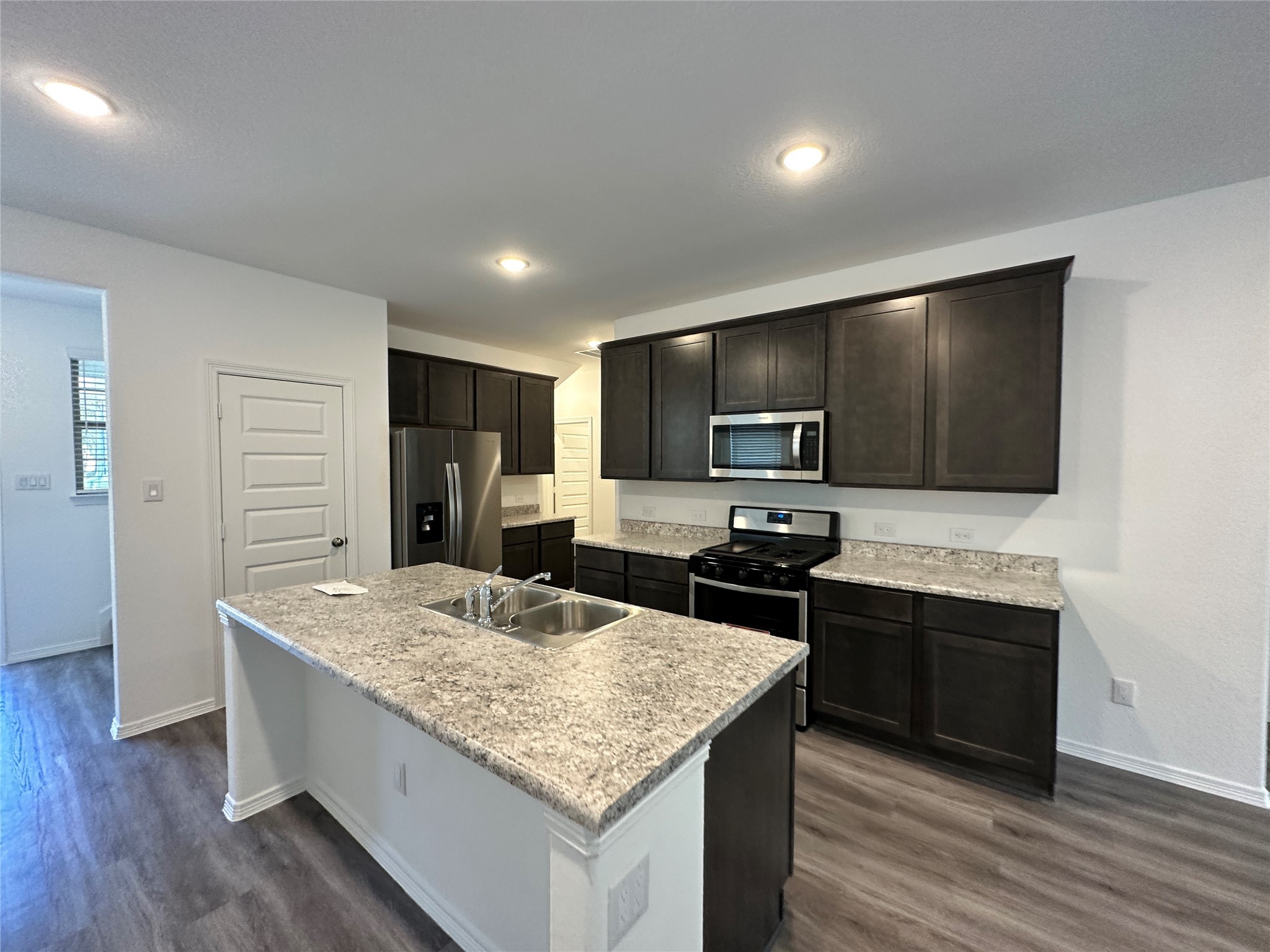 16572 Moss Lane Porter, TX 77365 - Photo 3 of 17 a kitchen with stainless steel appliances granite countertop a sink stove and refrigerator