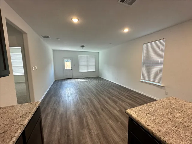 a view of kitchen and hallway with wooden floor