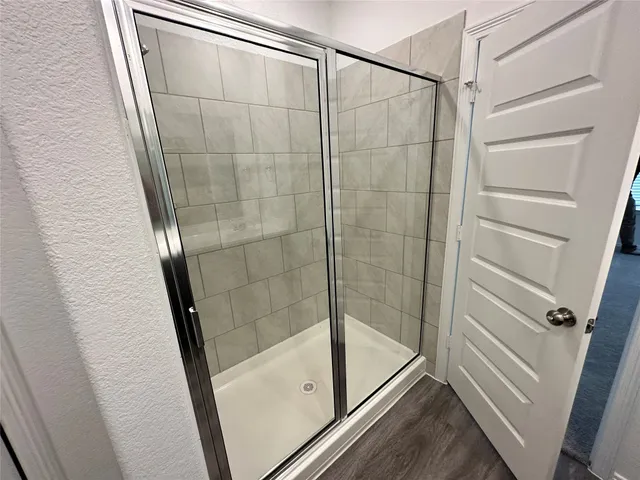 a bathroom with a glass door shower