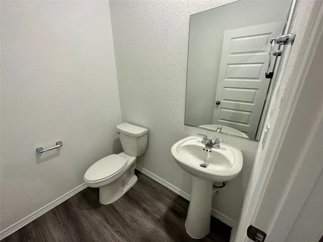 a bathroom with a sink toilet and a mirror
