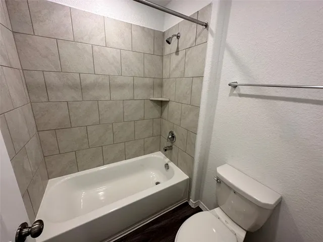 a bathroom with a bathtub and toilet
