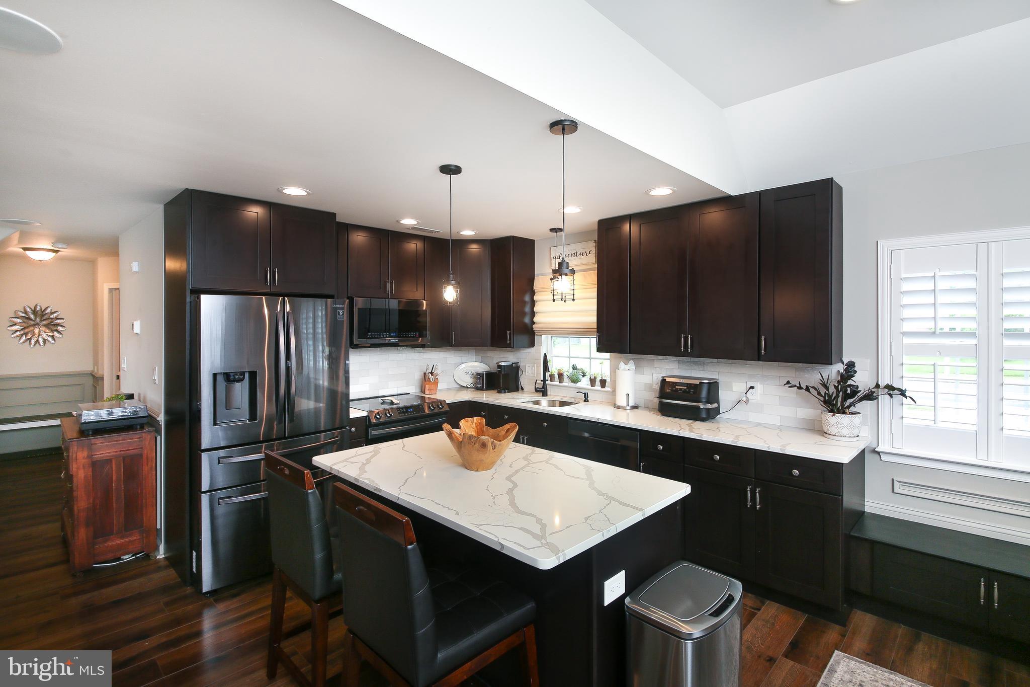 40 Greenbriar Road Levittown, PA 19057 - Photo 11 of 29 a kitchen with a sink a counter space cabinets and stainless steel appliances
