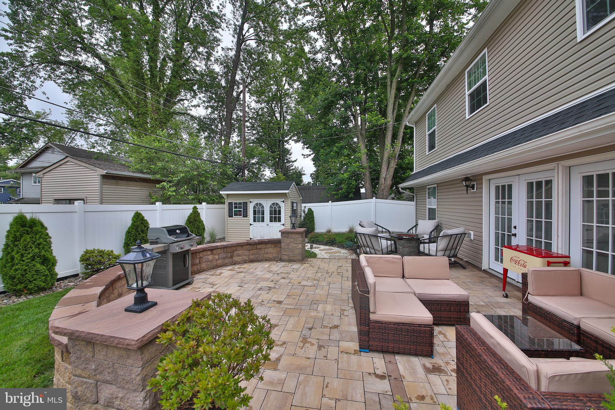 40 Greenbriar Road Levittown, PA 19057 - Photo 23 of 29 a view of a patio with couches table and chairs with wooden fence and plants