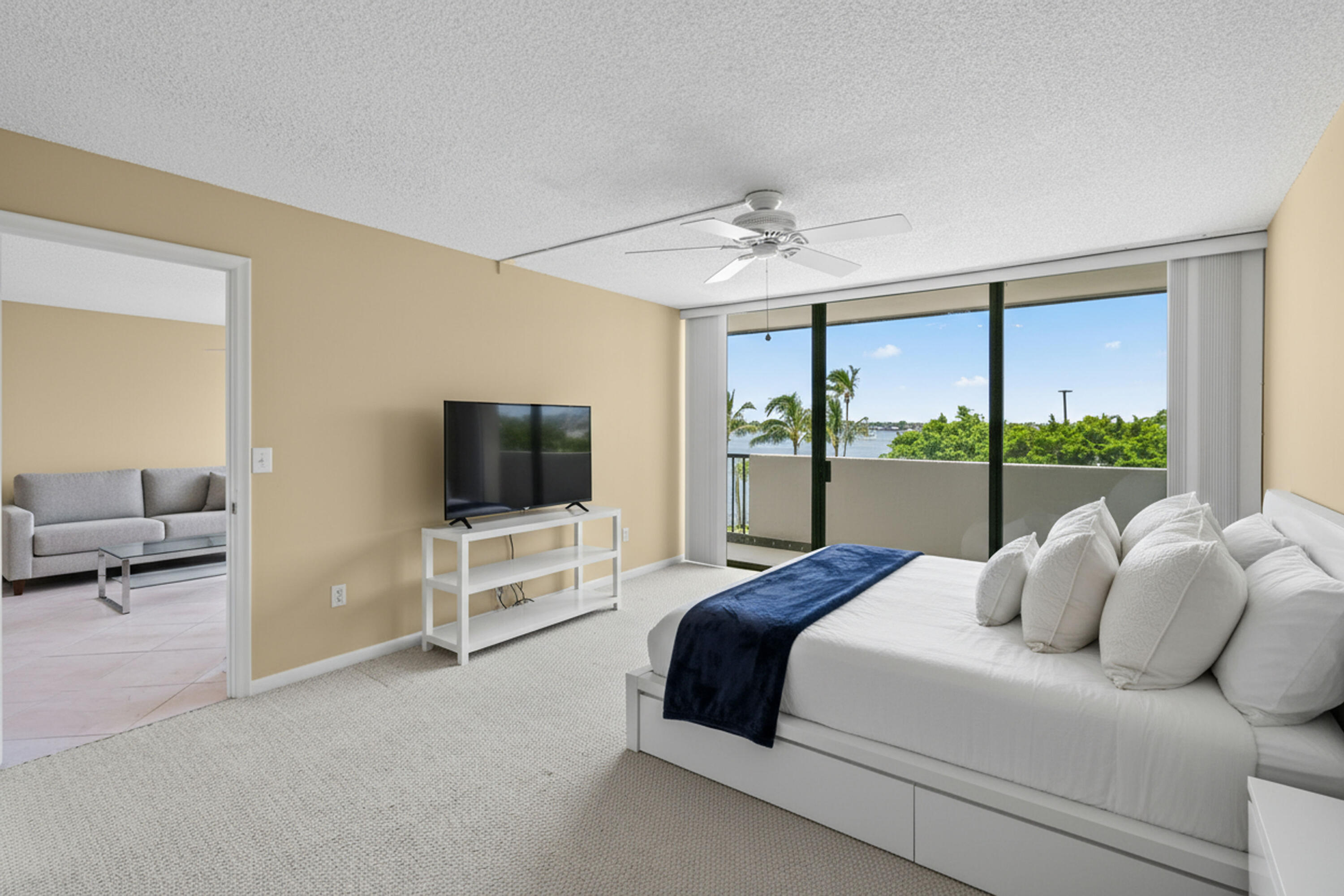 5200 North Flagler Drive, Unit 404 West Palm Beach, FL 33407 - Photo 12 of 33 a spacious bedroom with a bed and a television