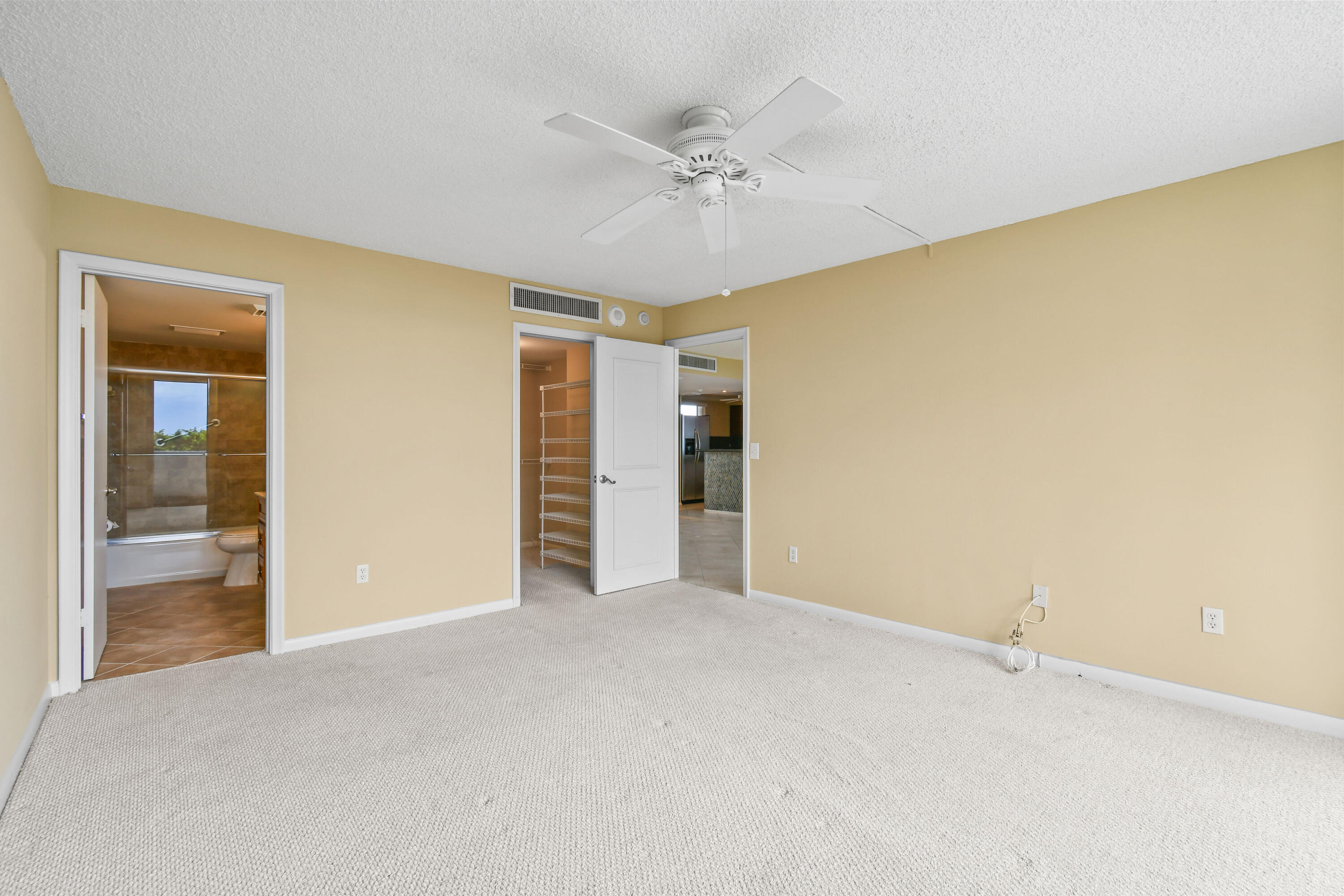 5200 North Flagler Drive, Unit 404 West Palm Beach, FL 33407 - Photo 14 of 33 a view of an empty room with a ceiling fan