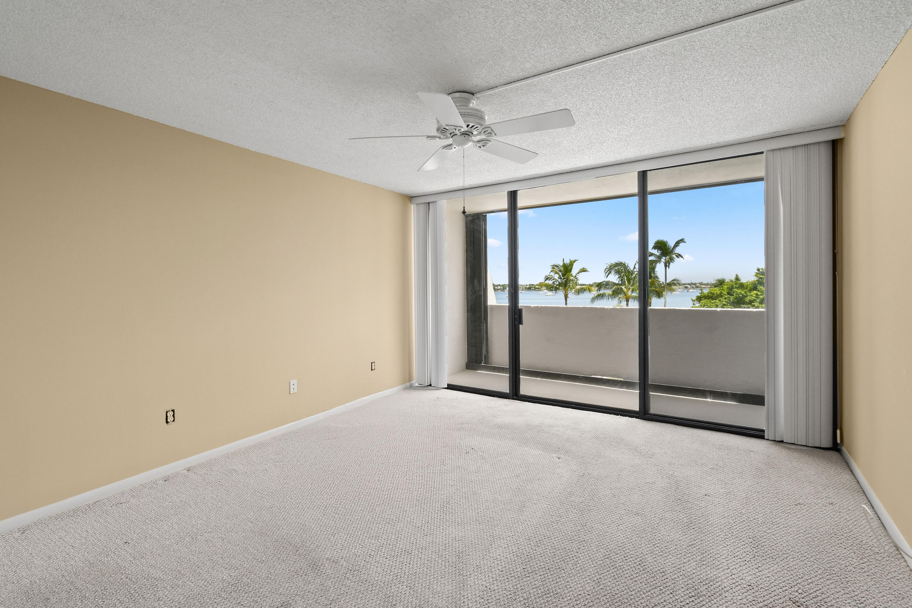 5200 North Flagler Drive, Unit 404 West Palm Beach, FL 33407 - Photo 17 of 33 an empty room with a ceiling fan and window