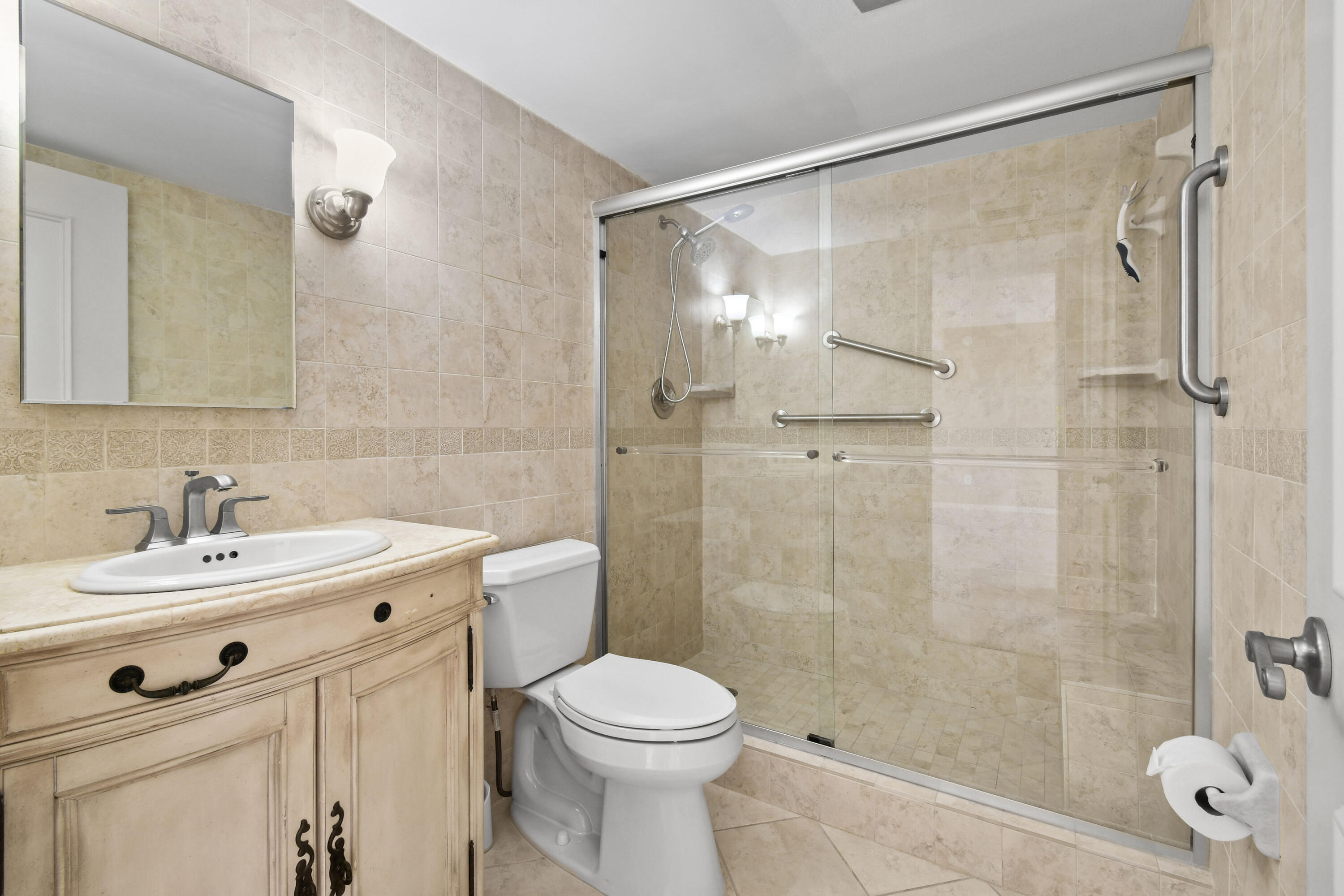 5200 North Flagler Drive, Unit 404 West Palm Beach, FL 33407 - Photo 20 of 33 a bathroom with a sink toilet a mirror and shower