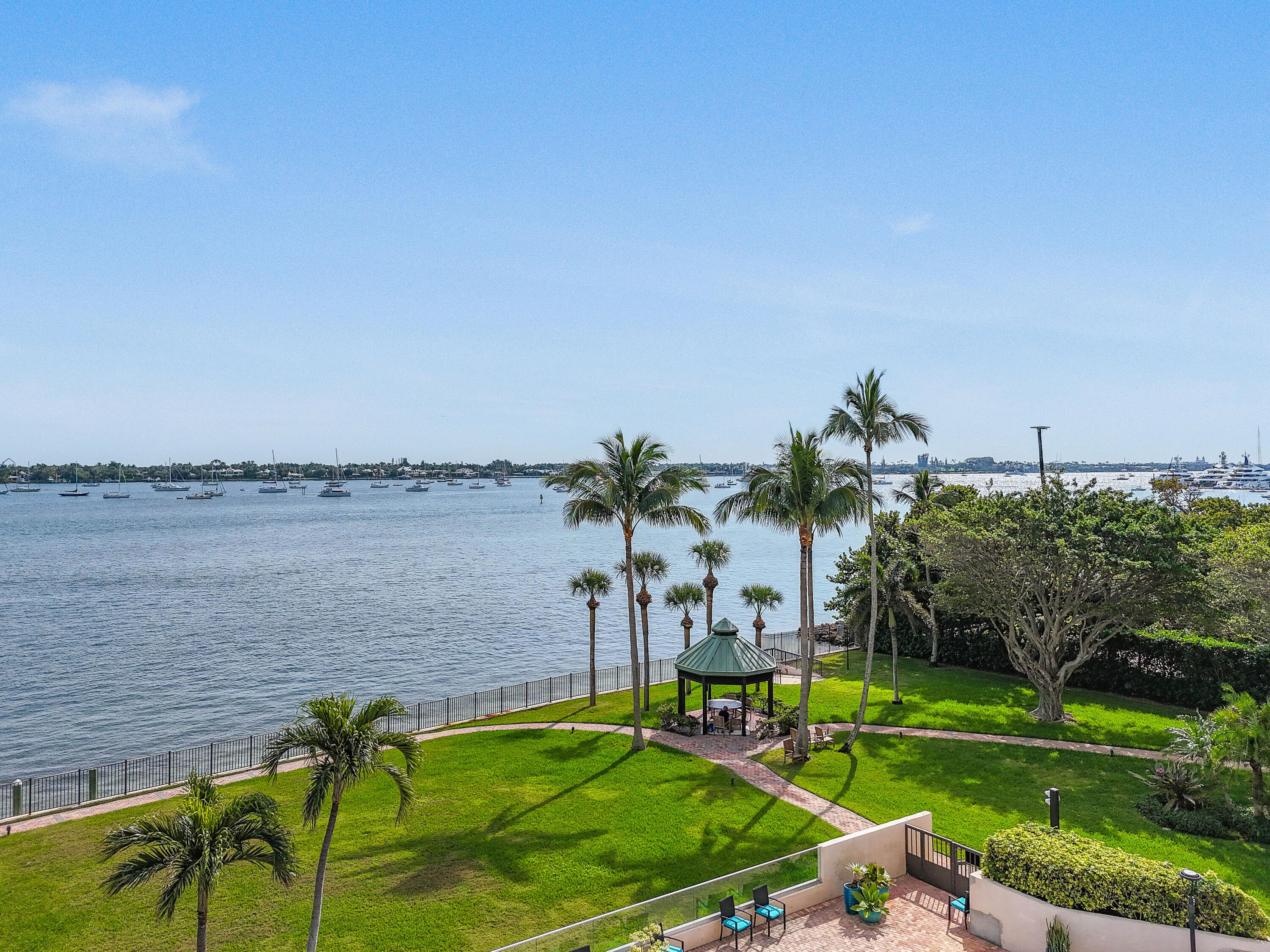 5200 North Flagler Drive, Unit 404 West Palm Beach, FL 33407 - Photo 24 of 33 a view of a swimming pool with a yard and a fountain