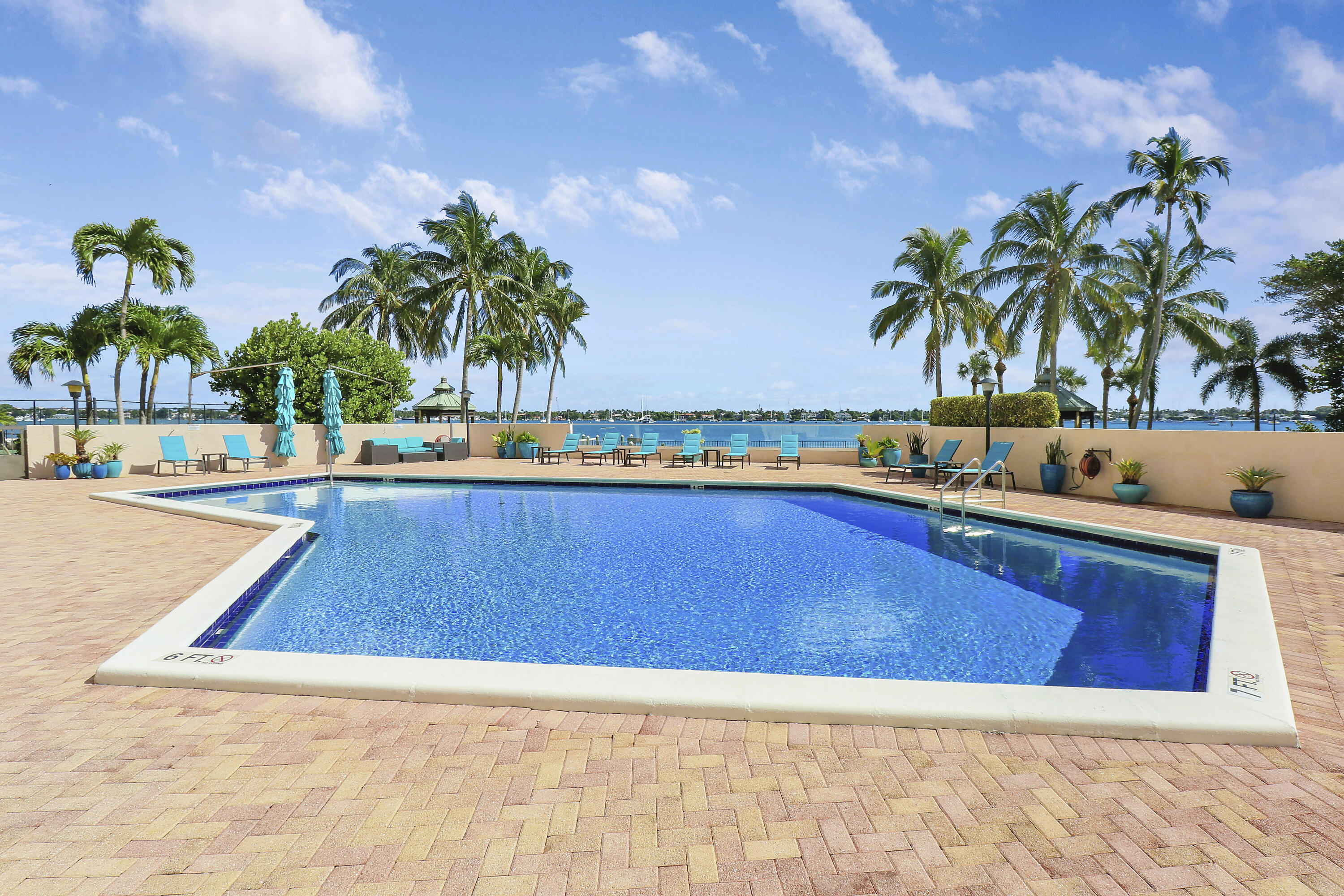 5200 North Flagler Drive, Unit 404 West Palm Beach, FL 33407 - Photo 29 of 33 a view of swimming pool with outdoor seating and house in the background
