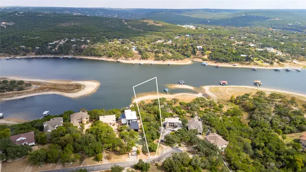 an aerial view of a house with a lake view