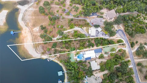 an aerial view of a house with a yard lake and mountain view