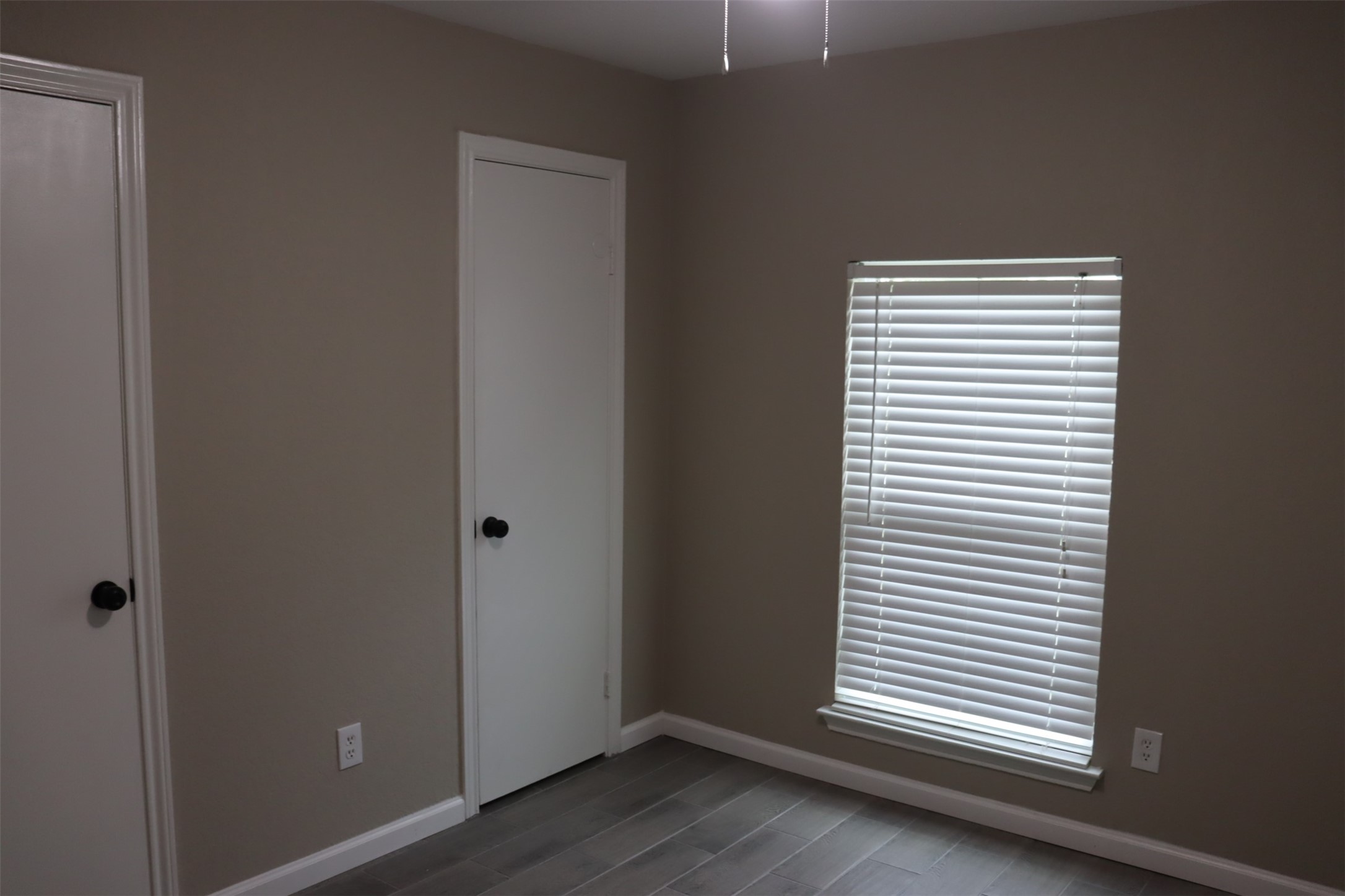 12507 New Rochelle Court Houston, TX 77089 - Photo 7 of 12 an empty room with wooden floor and windows