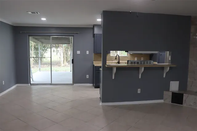 a view of kitchen with a sink cabinet and window
