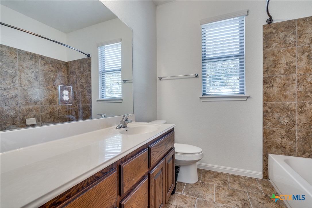 1019 Powell Kyle, TX 78640 - Photo 9 of 17 a bathroom with a sink a toilet and a bathtub