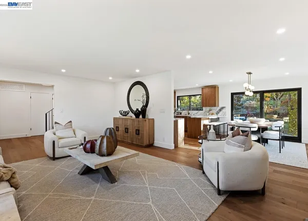a utility room with a sink a refrigerator and wooden floor