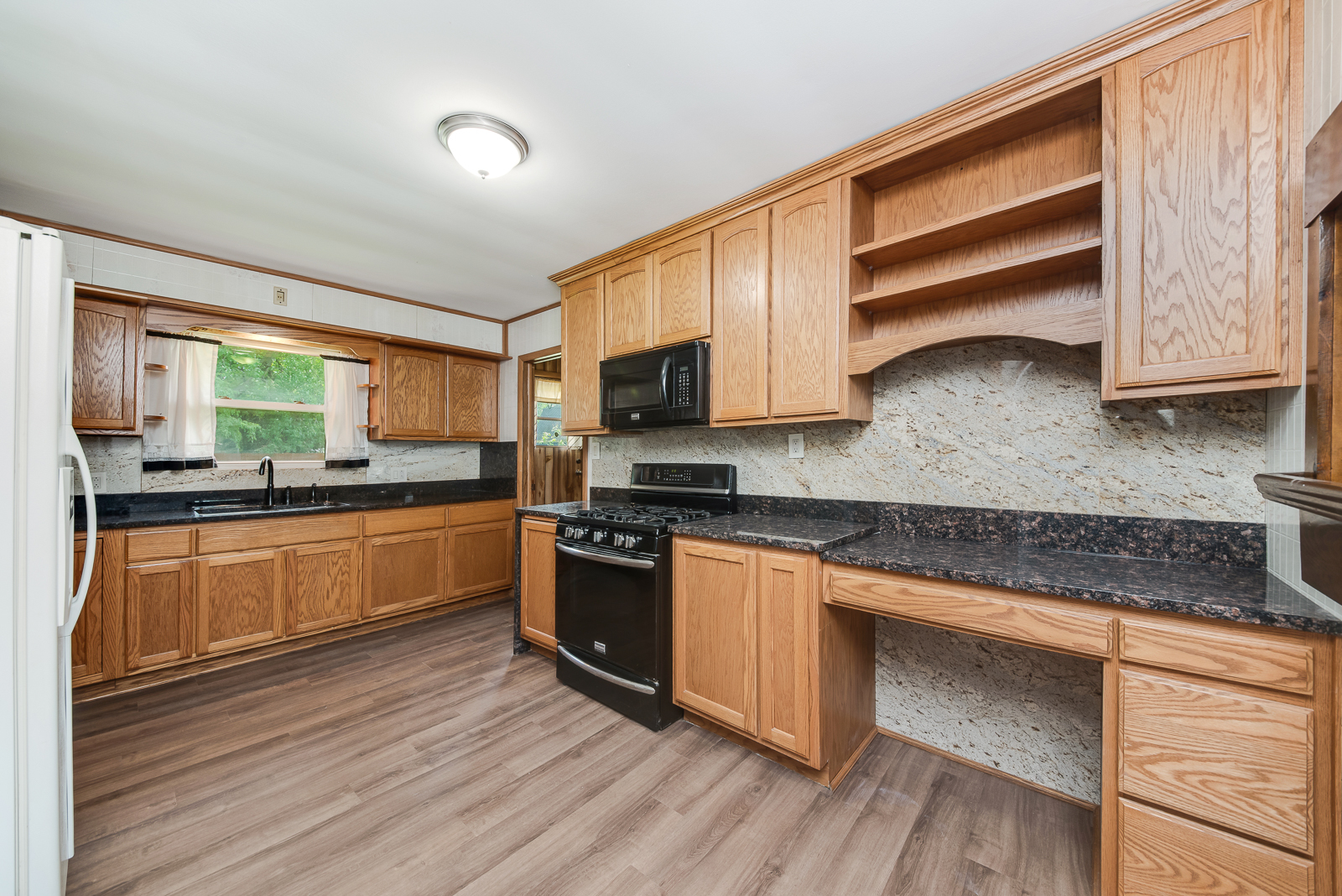 318 East North Street Lockport, IL 60441 - Photo 3 of 14 a kitchen with stainless steel appliances kitchen island granite countertop wooden floors wooden cabinets and sink