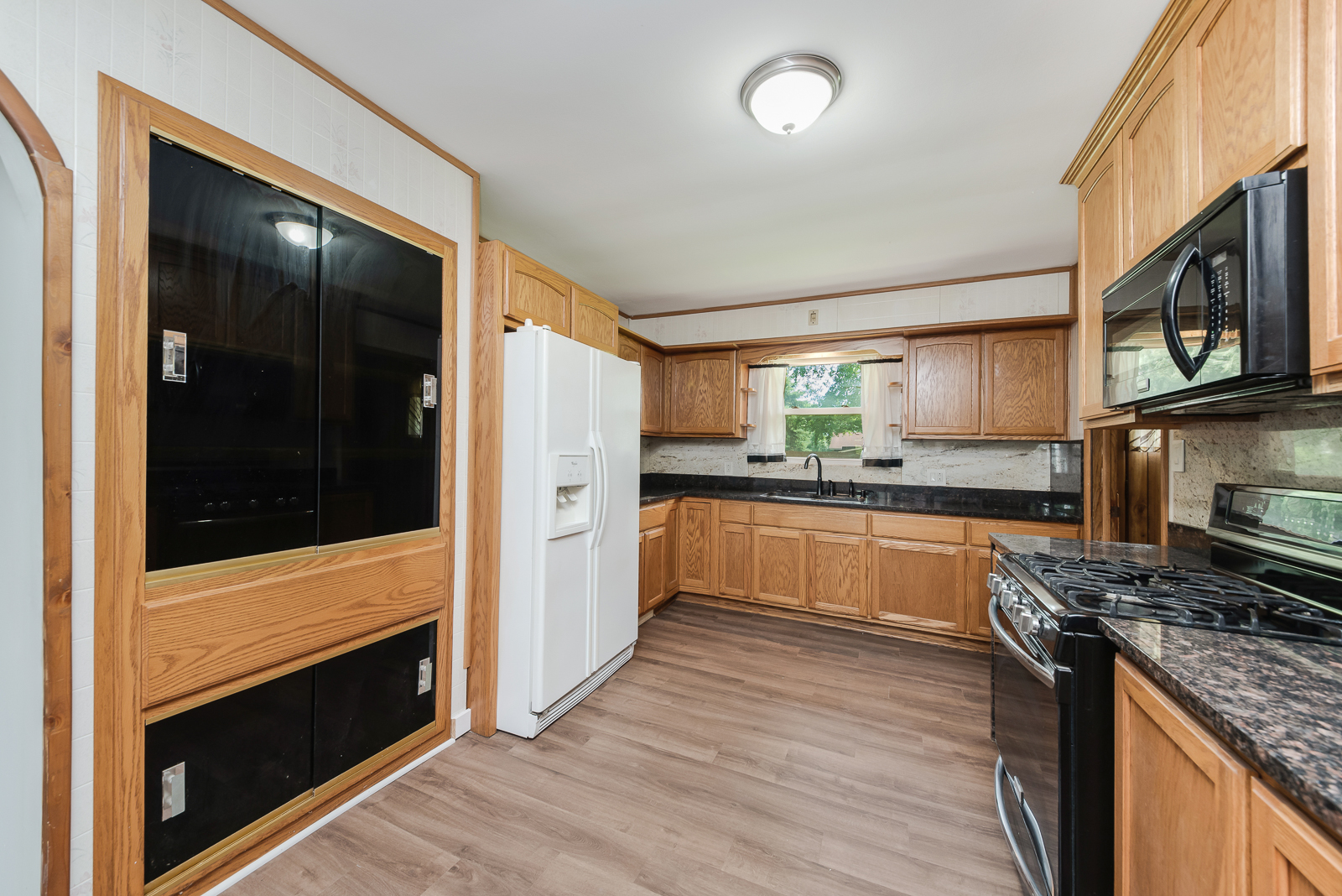 318 East North Street Lockport, IL 60441 - Photo 4 of 14 a kitchen with stainless steel appliances granite countertop wooden cabinets and a stove top oven