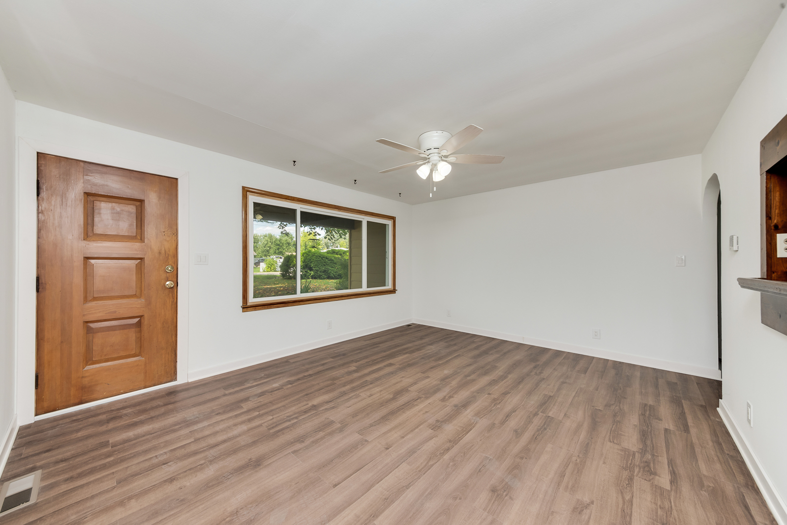 318 East North Street Lockport, IL 60441 - Photo 7 of 14 a view of an empty room with a window and wooden floor