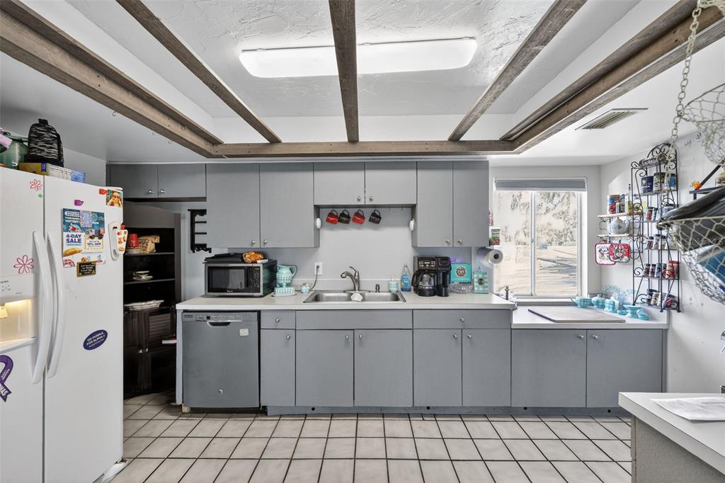 3010 Shepherd Road Mulberry, FL 33860 - Photo 8 of 28 a kitchen with a sink a refrigerator and cabinets