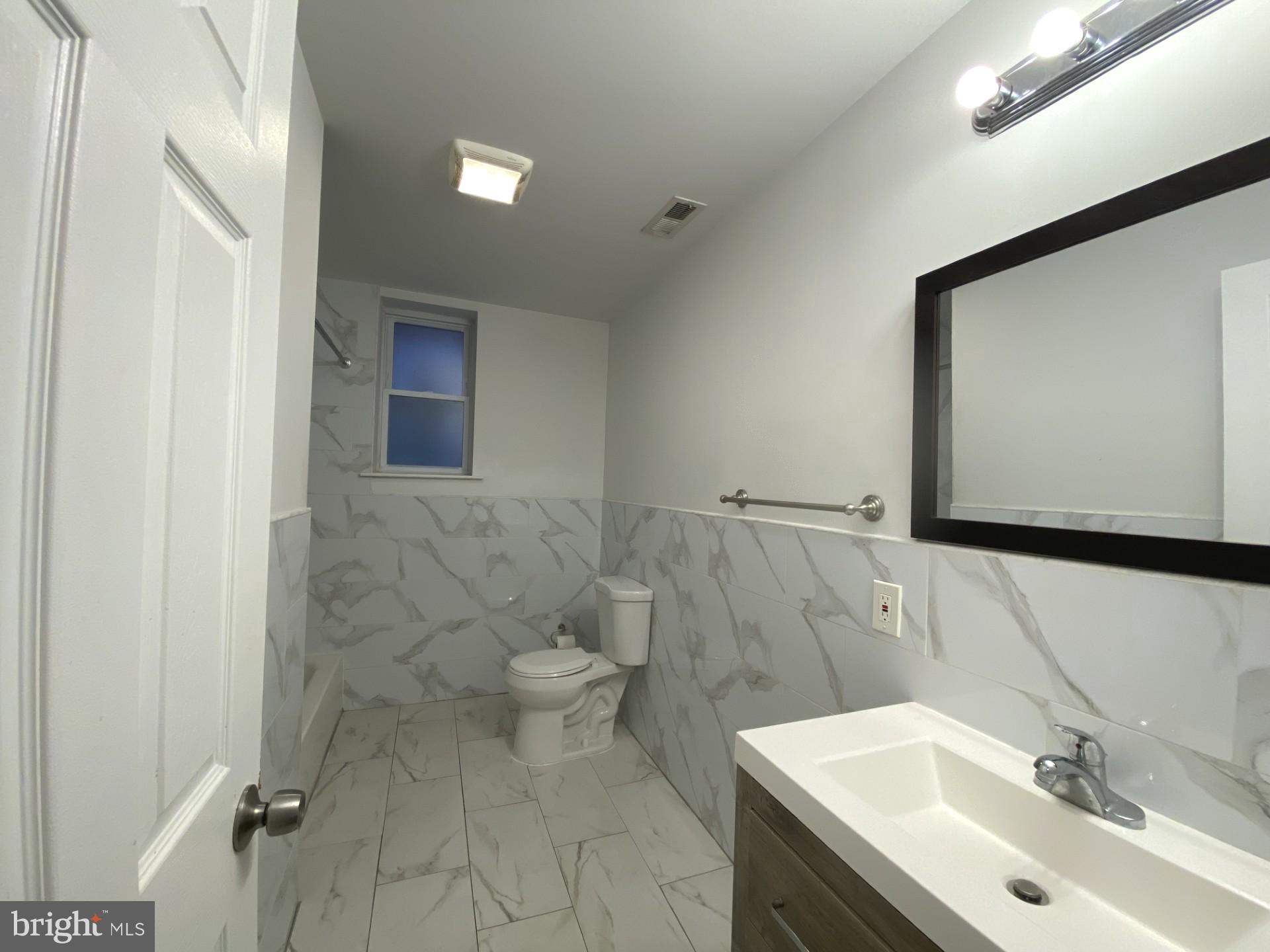4945 Chestnut Street Philadelphia, PA 19139 - Photo 21 of 27 a bathroom with a sink and mirror