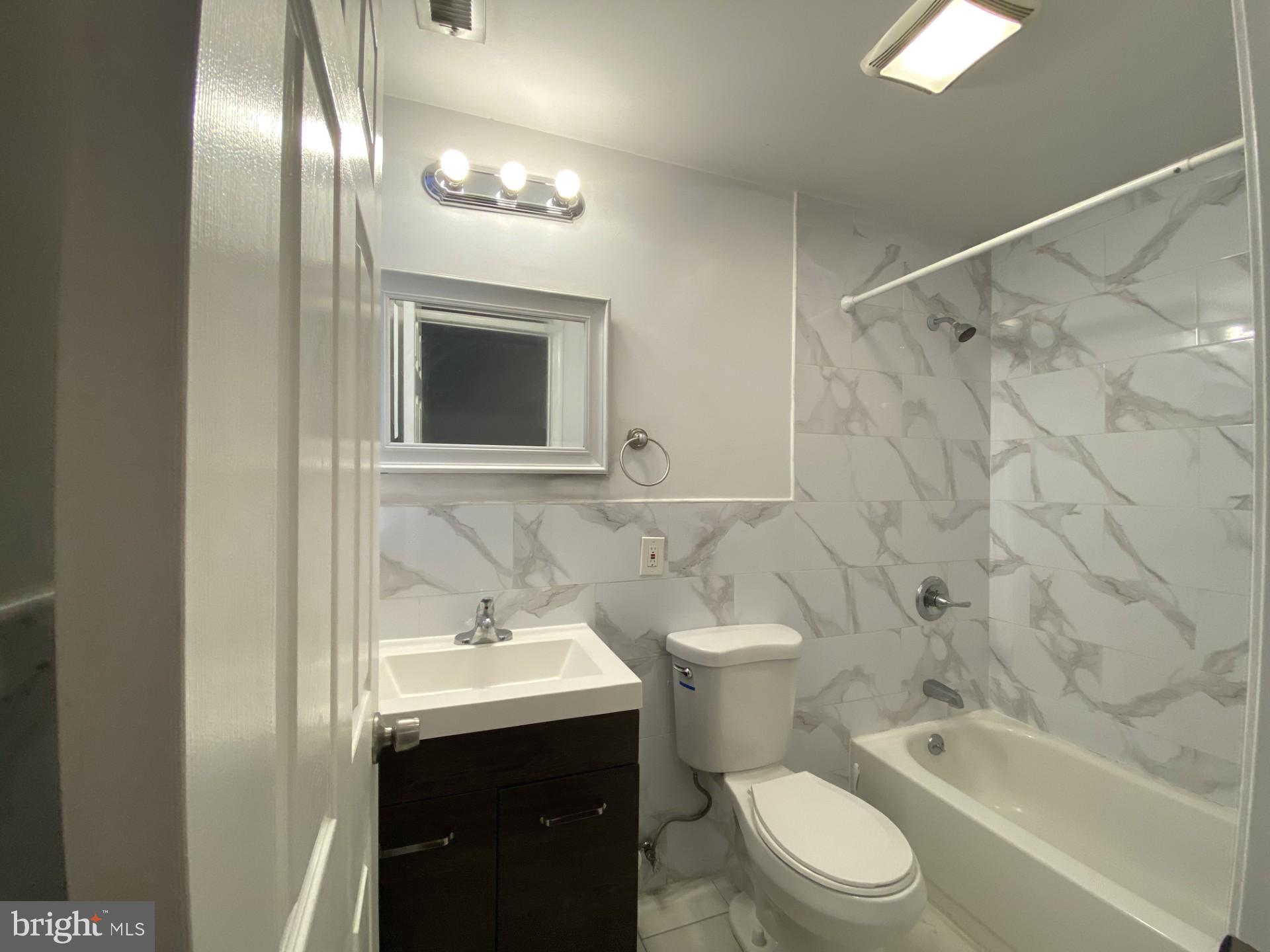 4945 Chestnut Street Philadelphia, PA 19139 - Photo 25 of 27 a bathroom with a sink a toilet and shower
