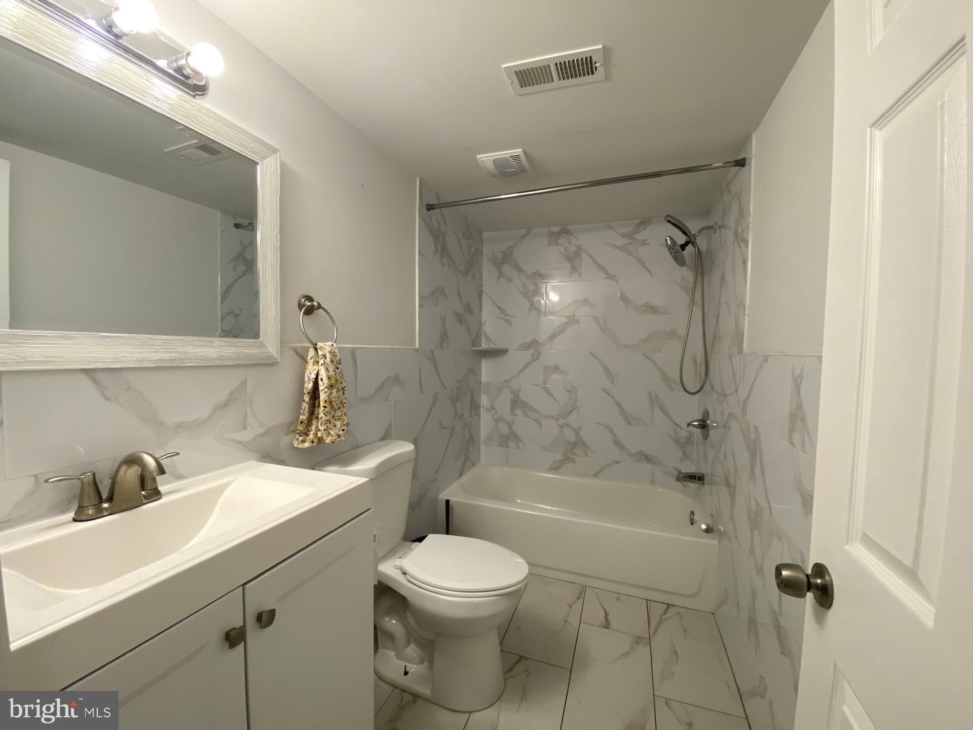 4945 Chestnut Street Philadelphia, PA 19139 - Photo 9 of 27 a bathroom with a sink toilet and shower