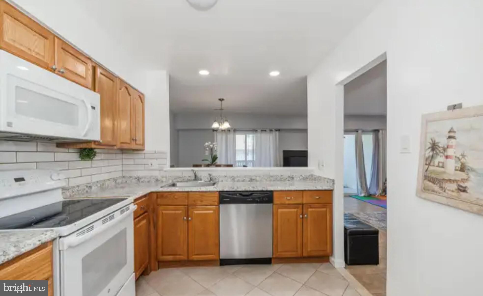 3919 El Soneta Place, Unit 9 Alexandria, VA 22309 - Photo 8 of 17 a kitchen with stainless steel appliances granite countertop a stove and a sink