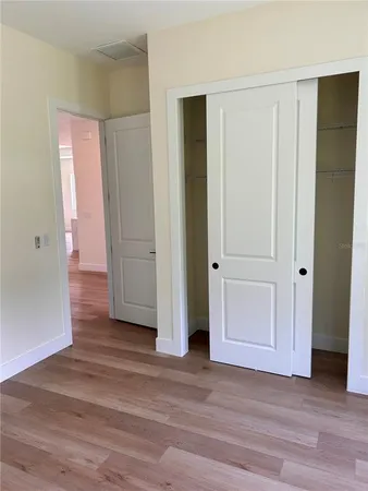 an empty room with wooden floor