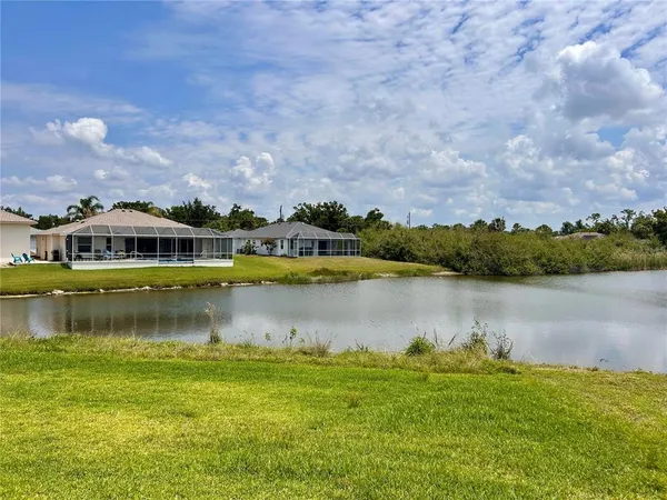 a view of a lake with houses in the background