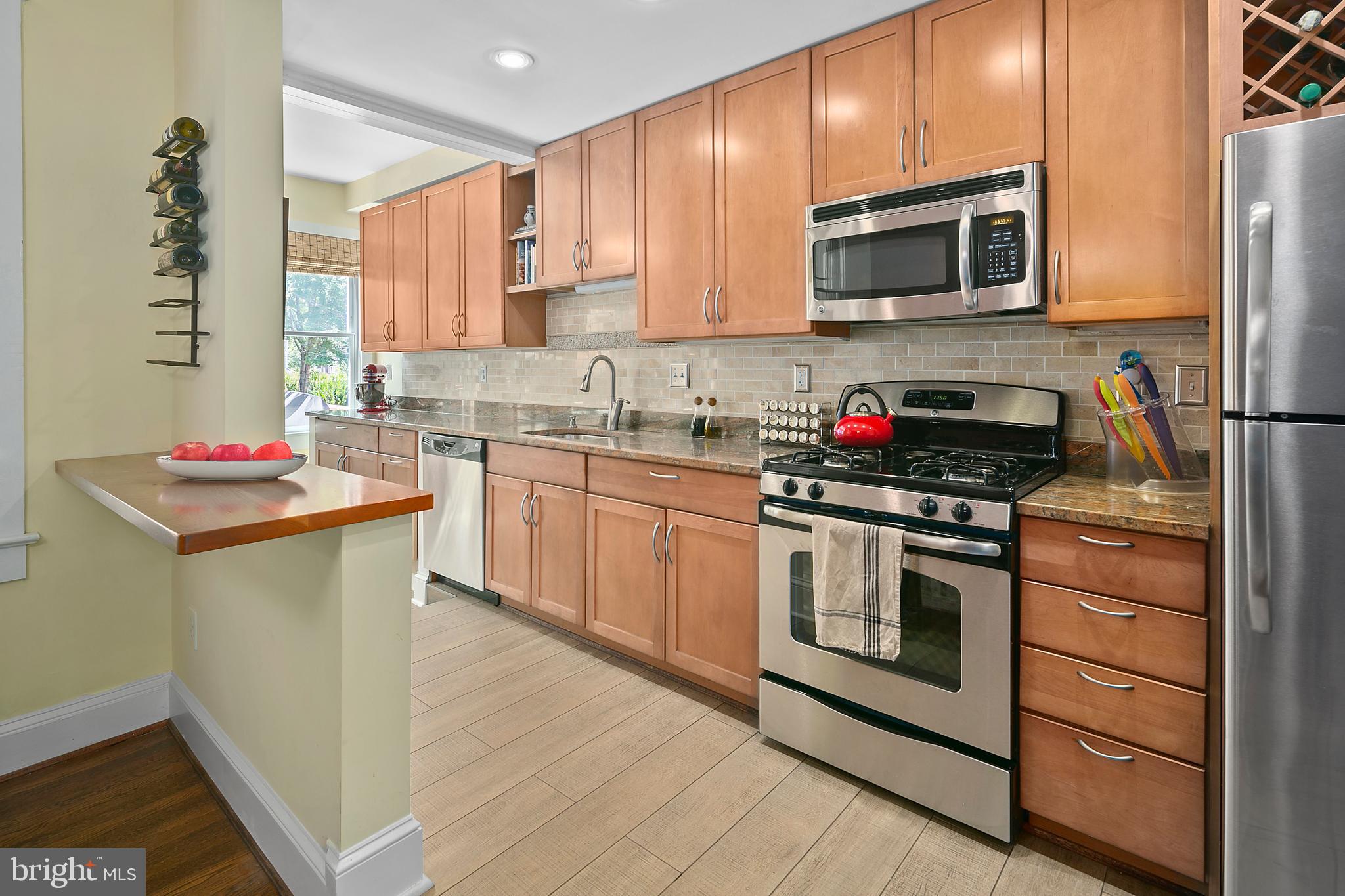 925 K Street Northeast Washington, DC 20002 - Photo 11 of 35 a kitchen with stainless steel appliances a stove microwave and sink