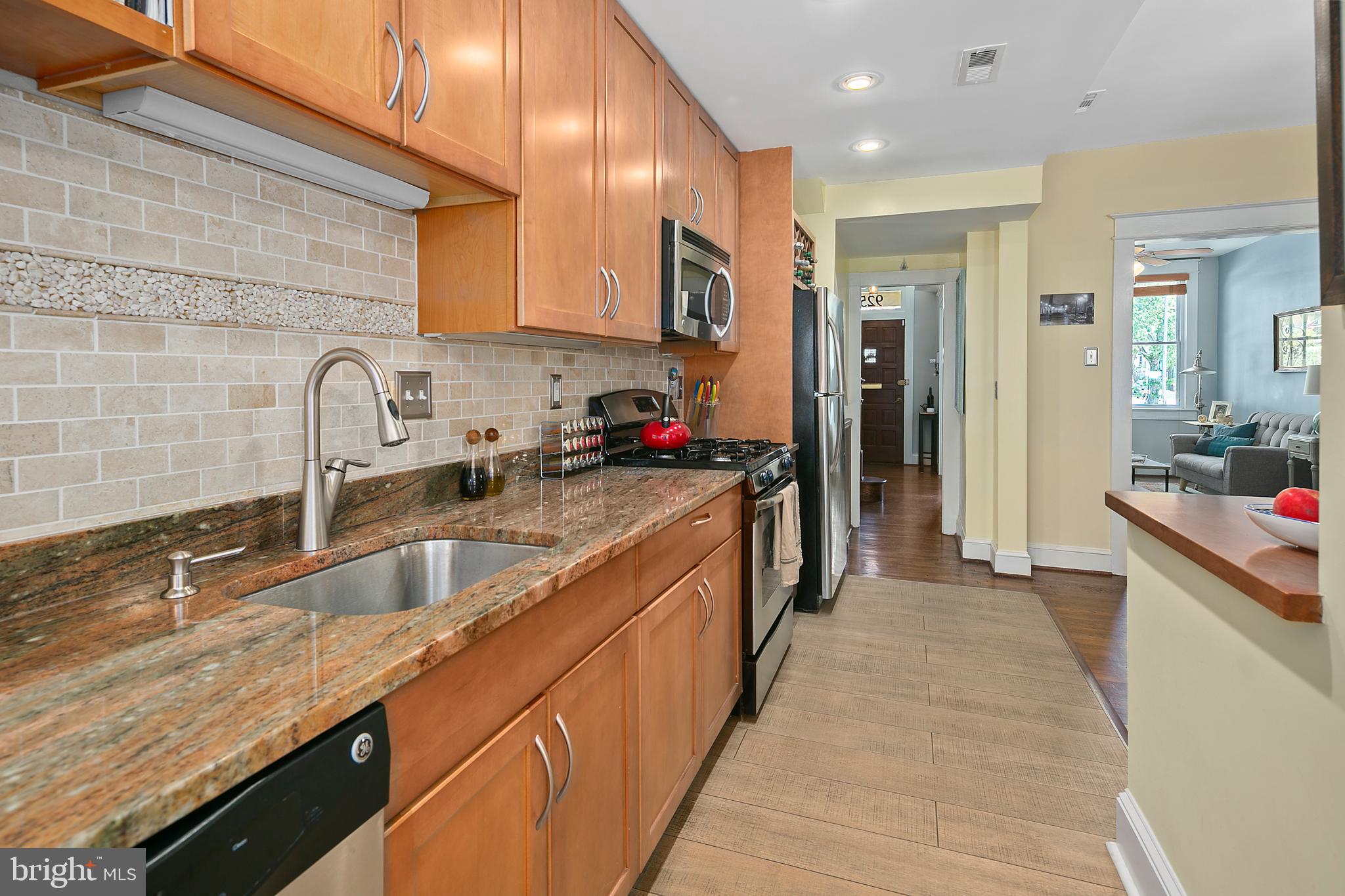 925 K Street Northeast Washington, DC 20002 - Photo 13 of 35 a kitchen with stainless steel appliances granite countertop a sink stove and refrigerator